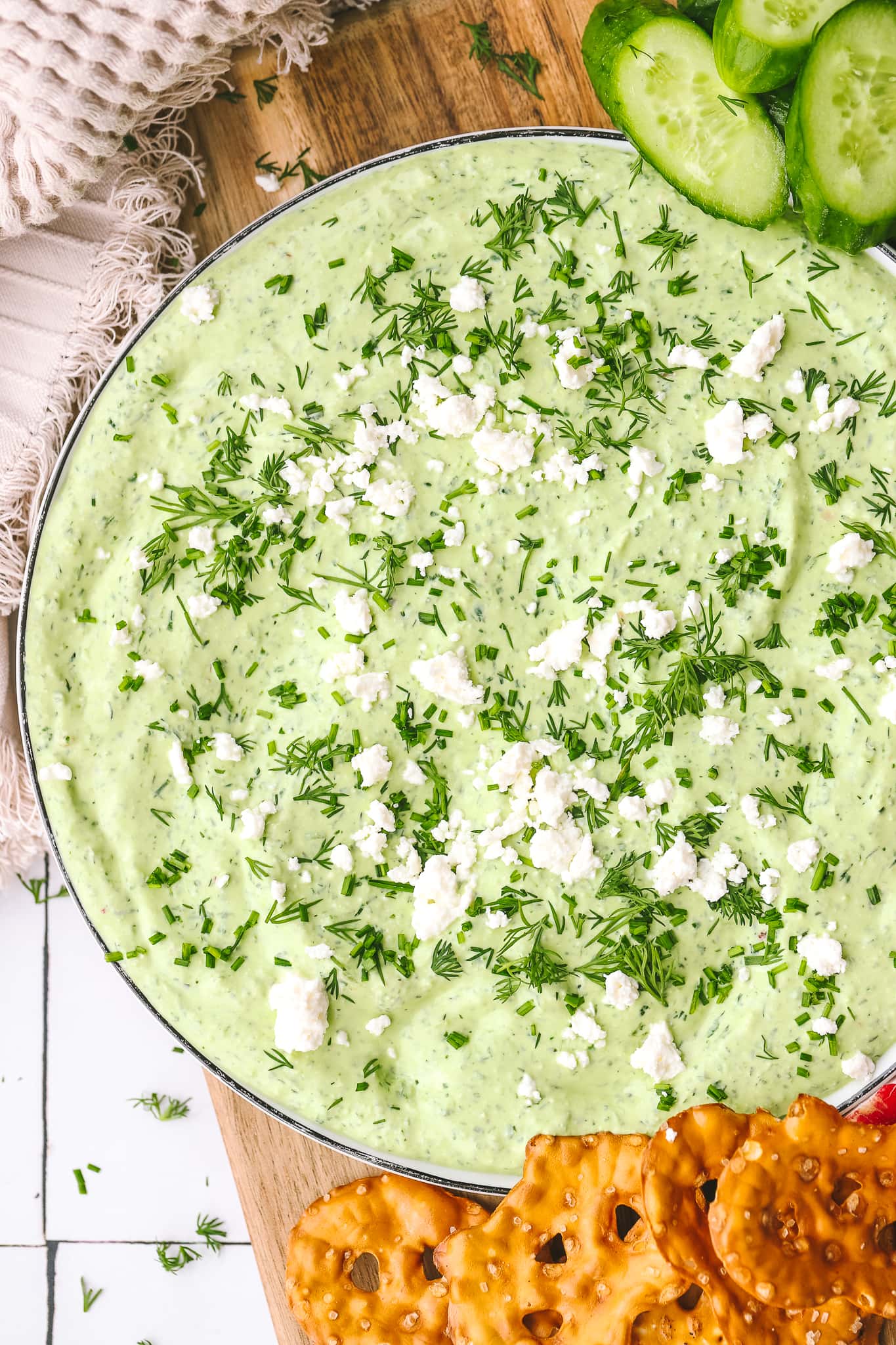 fresh herbs and feta on top of green goddess dip