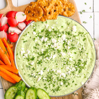 green goddess dip on a plate with vegetables and crackers