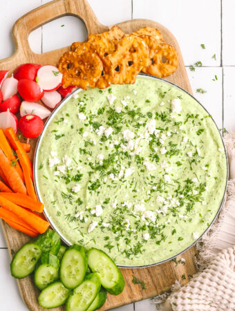 green goddess dip on a plate with vegetables and crackers