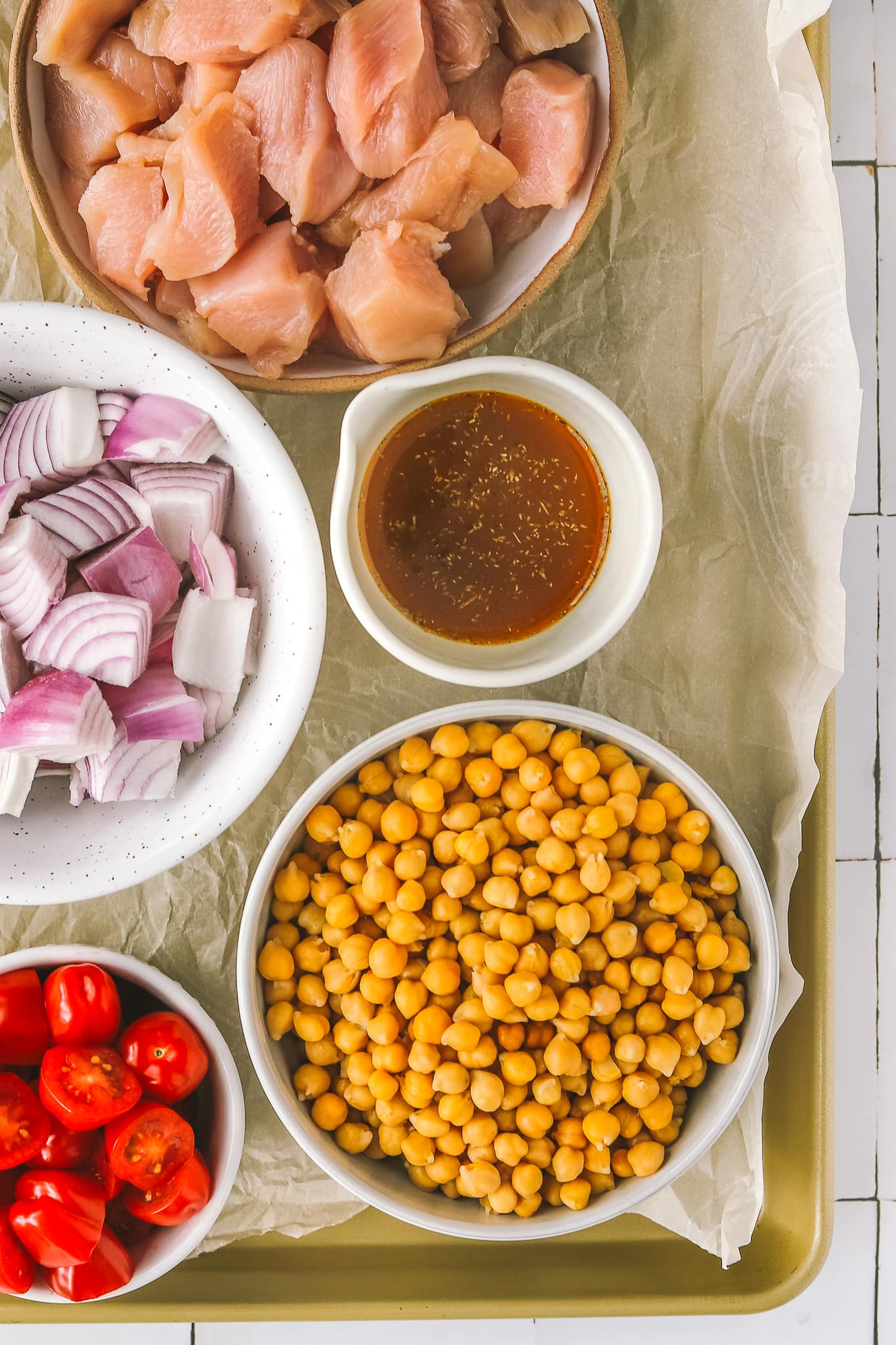 chickpeas, onions, chicken and tomatoes in bowls
