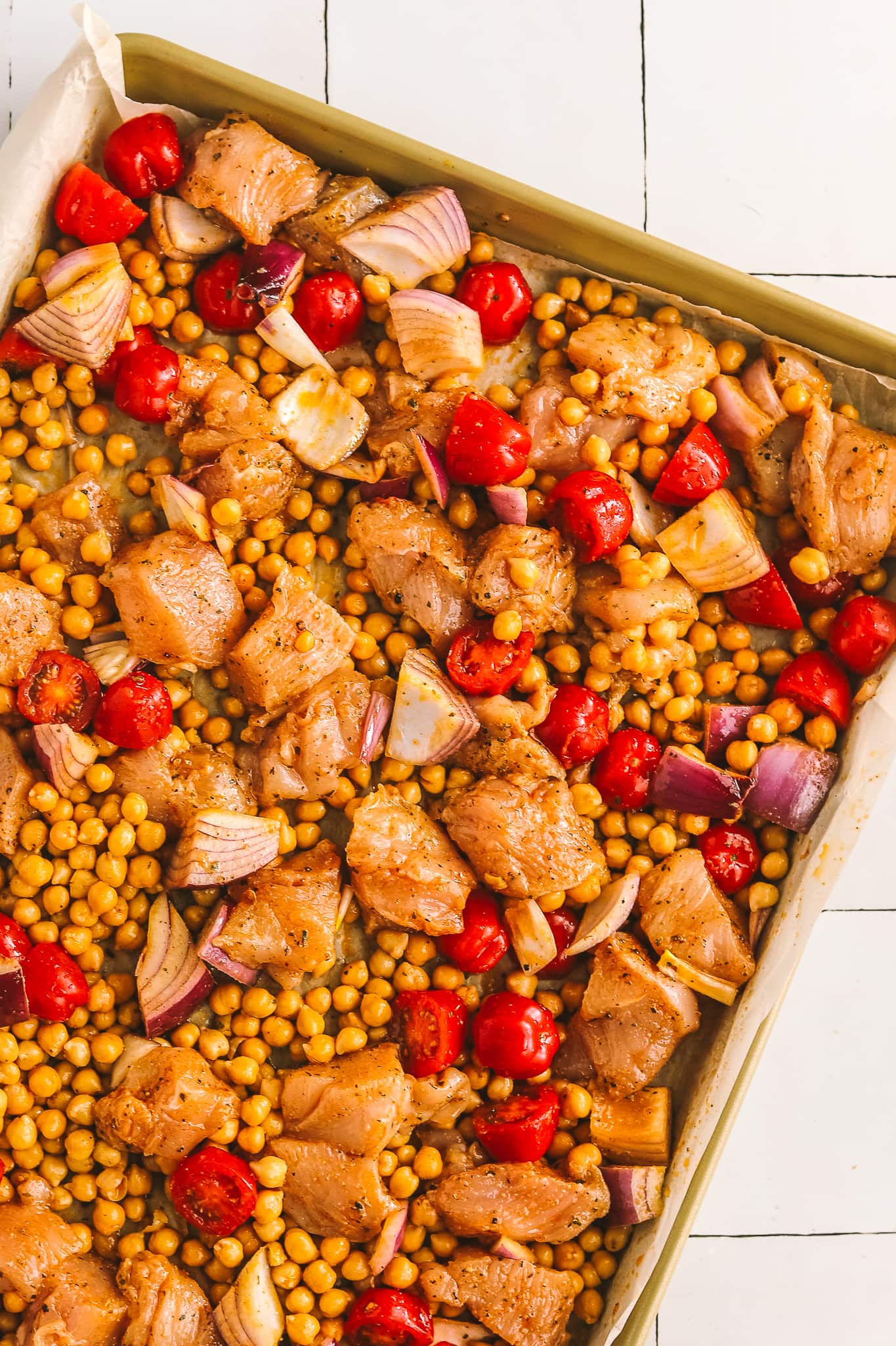 chicken, chickpeas and tomatoes on a sheet pan
