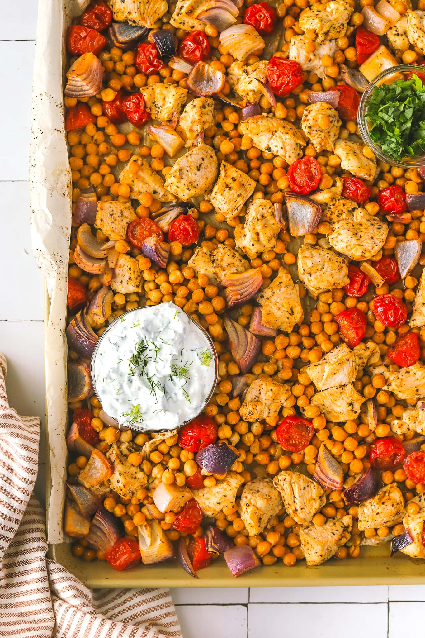 roasted chicken with chickpeas and tomatoes on a sheet pan