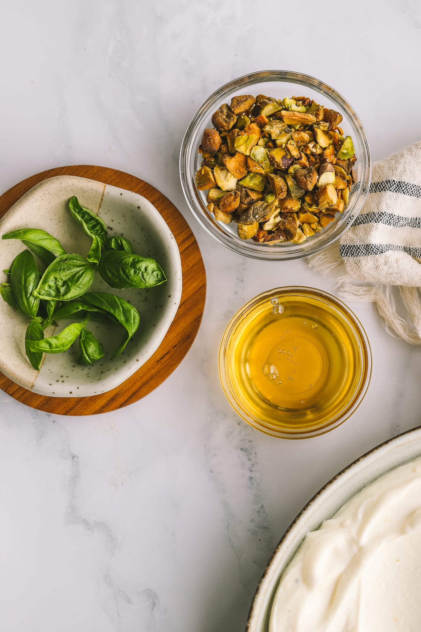 fresh basil, chopped pistachios and honey in bowls