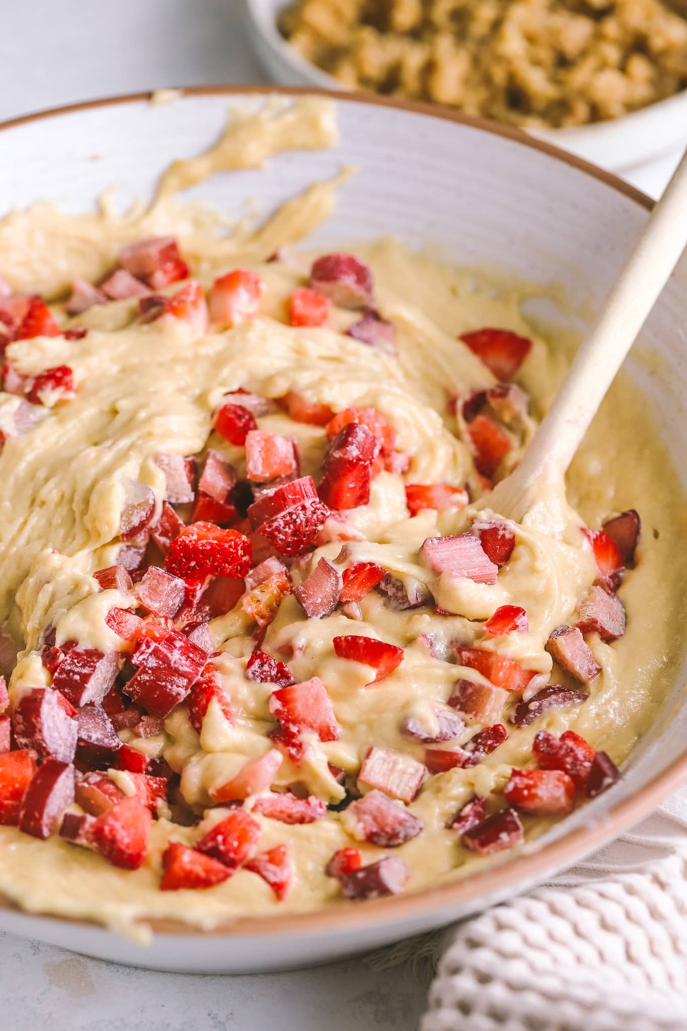 mixing bowl with strawberries and muffin batter