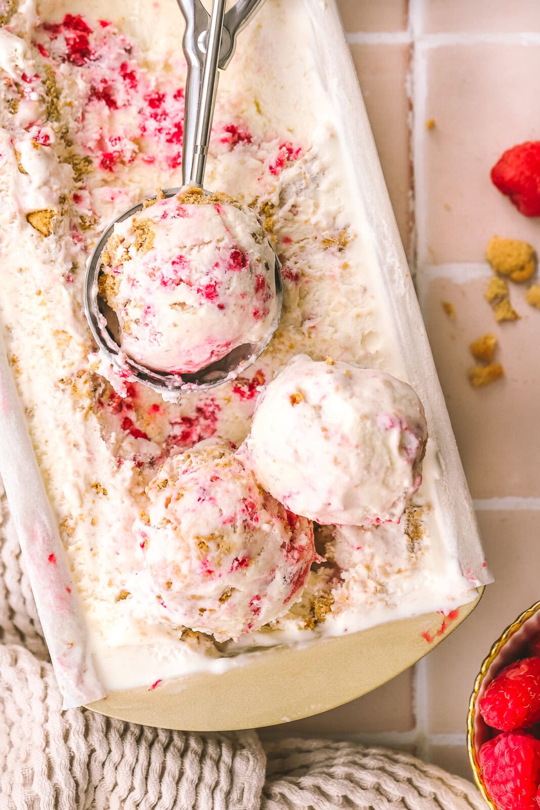 close up of scoops of raspberry ice cream in a loaf pan