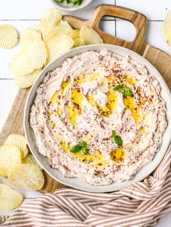 sundried tomato dip in a serving bowl with chips