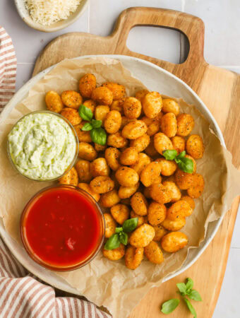 air fryer gnocchi on a plate with two dipping sauces