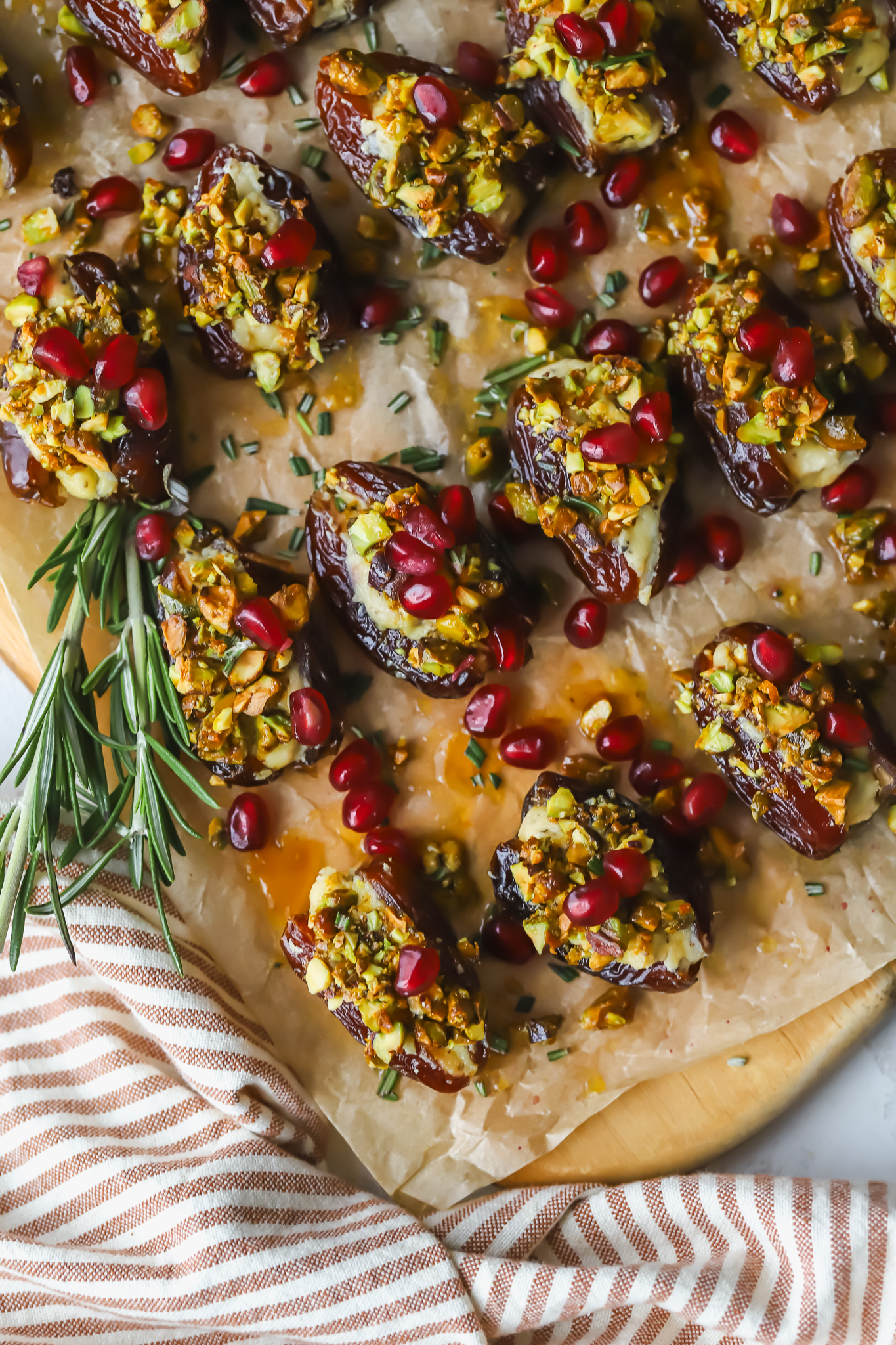 serving tray of stuffed boursin dates with pomegranate seeds and pistachios