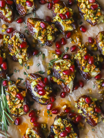 serving tray of stuffed dates with pomegranate seeds and pistachios