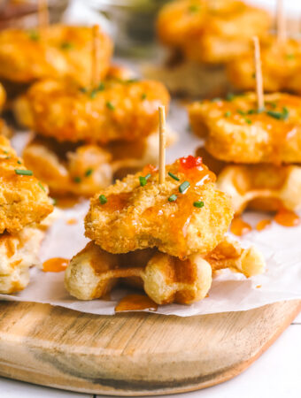 mini chicken & waffles appetizer with hot honey on a serving board