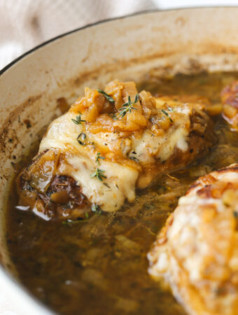 close up of chicken with caramelized onions and melted gruyere cheese