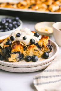 a piece of blueberry breakfast bake topped with maple cream cheese topping