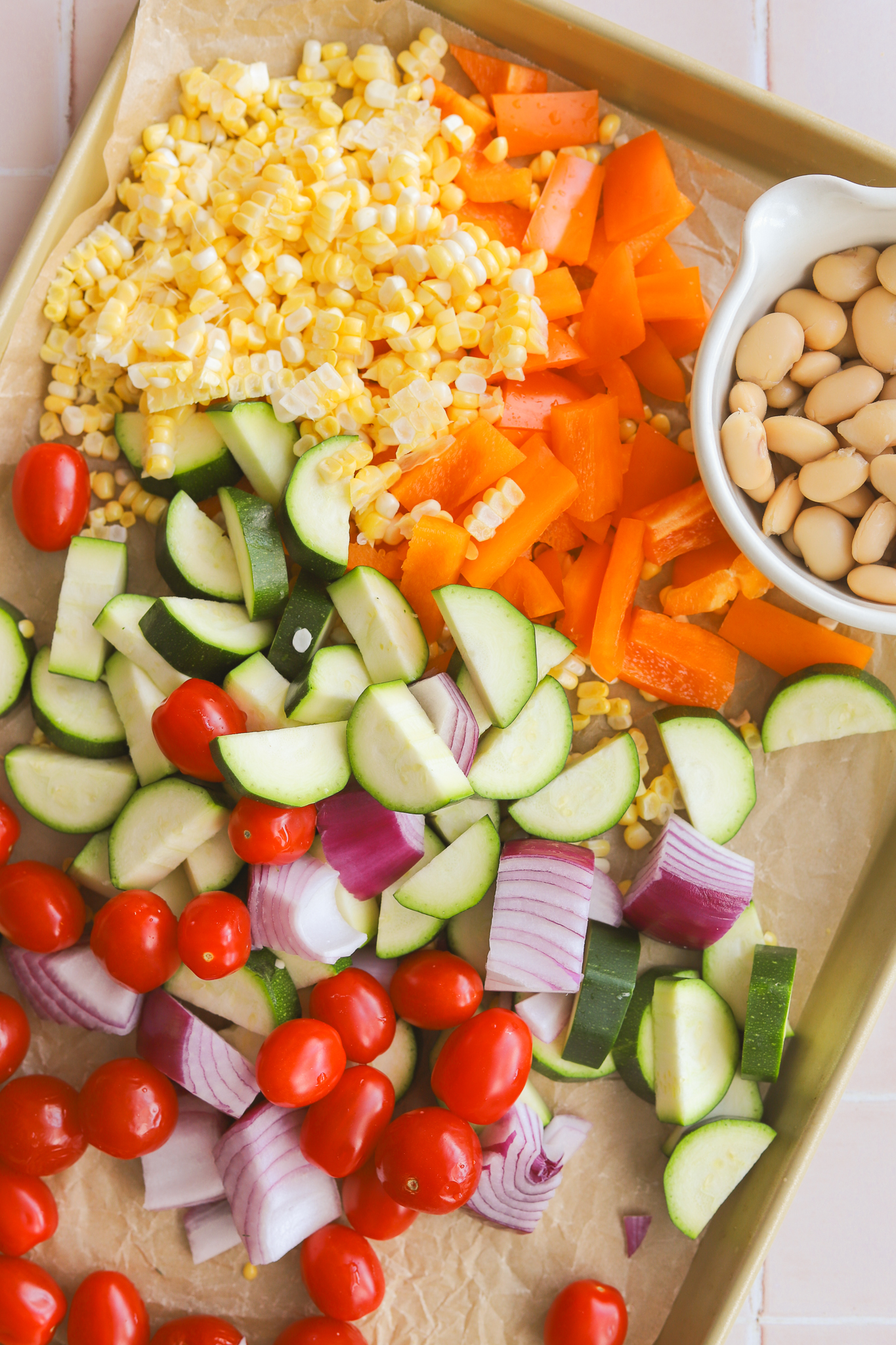 summer vegetables chopped up on a sheet pan