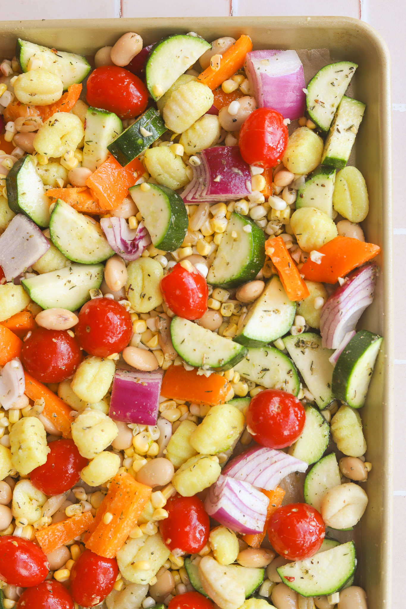 summer vegetables chopped up on a sheet pan