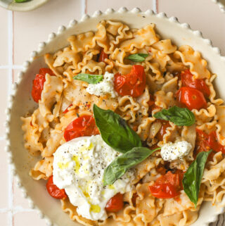 overhead of burst cherry tomato pasta in a bowl