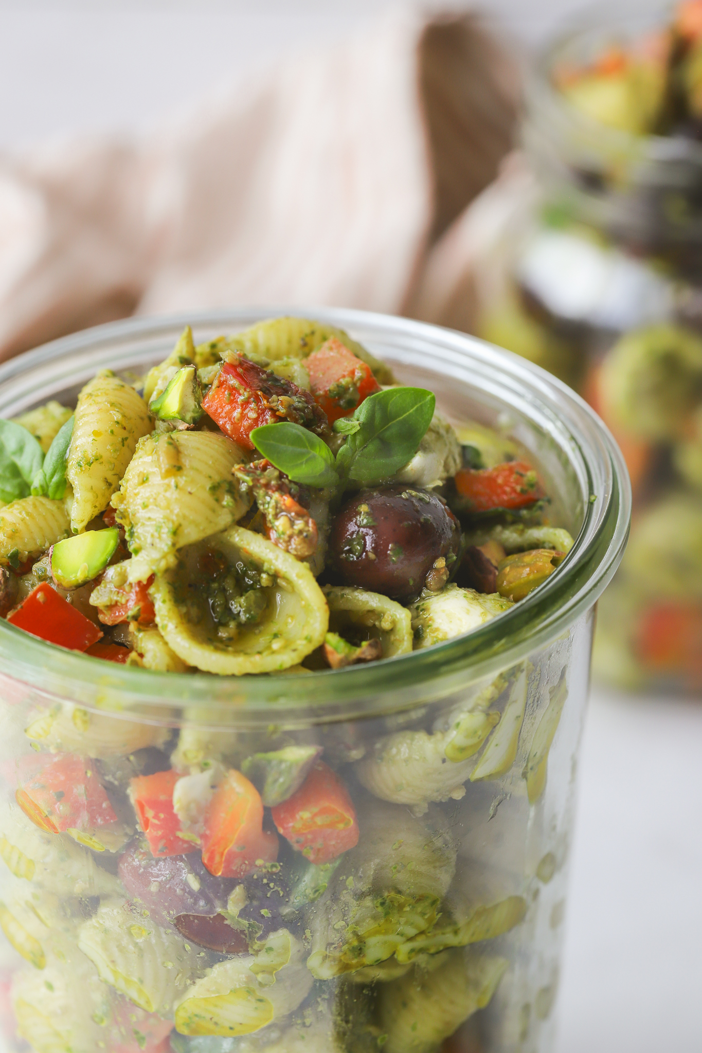 close up of the top of a mason jar full of pasta salad