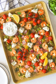 cooked shrimp and vegetables on a sheet pan