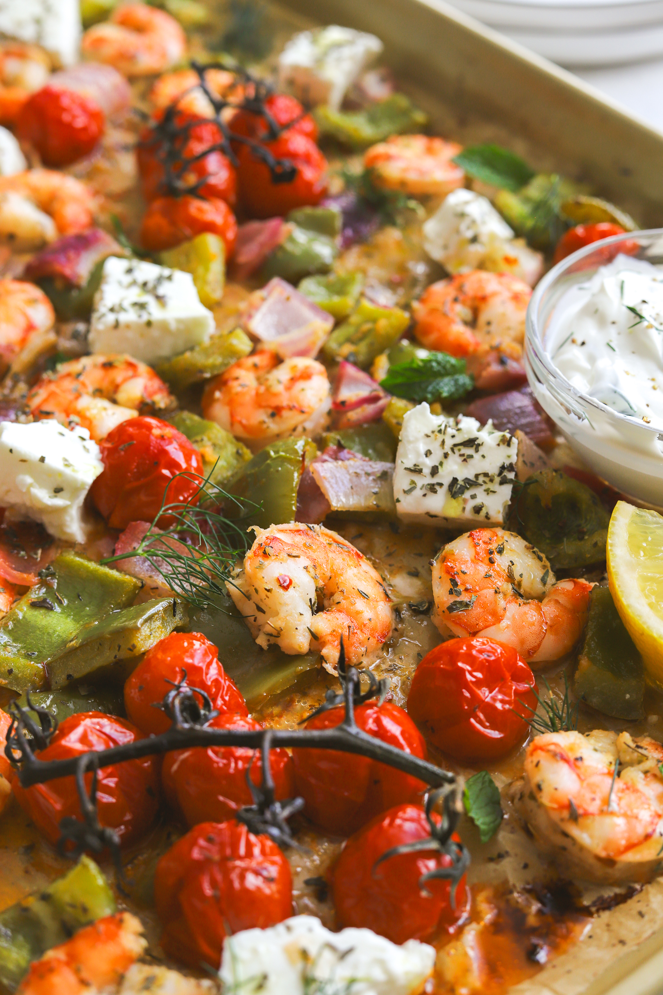 close up of cooked shrimp and vegetables on a sheet pan