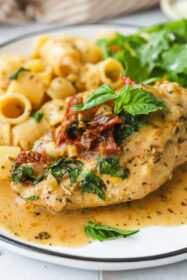 Easy and Delicious Crockpot Marry Me Chicken Recipe close up of sundried tomato chicken on a plate