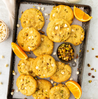 orange pistachio white chocolate cookies on a baking sheet