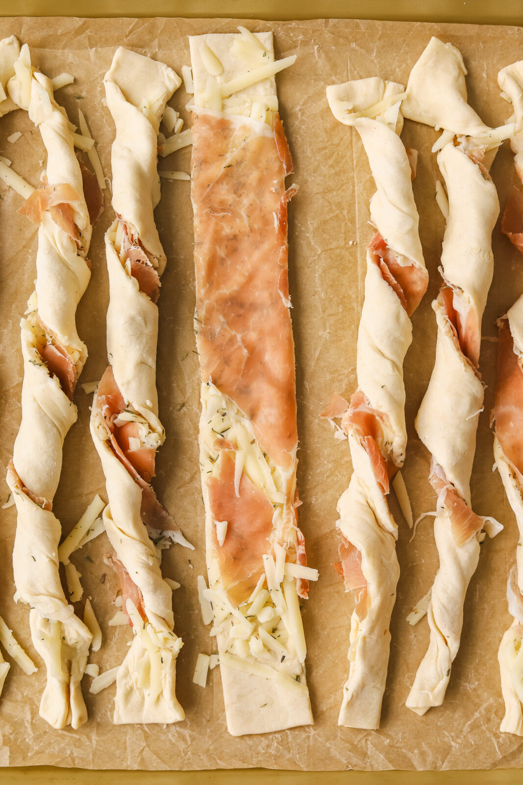 puff pastry cheese strips on a baking sheet