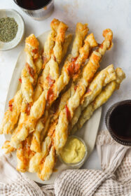 5-Ingredient Puff Pastry Cheese Twists with Gruyère cheese twists on a serving platter with mustard