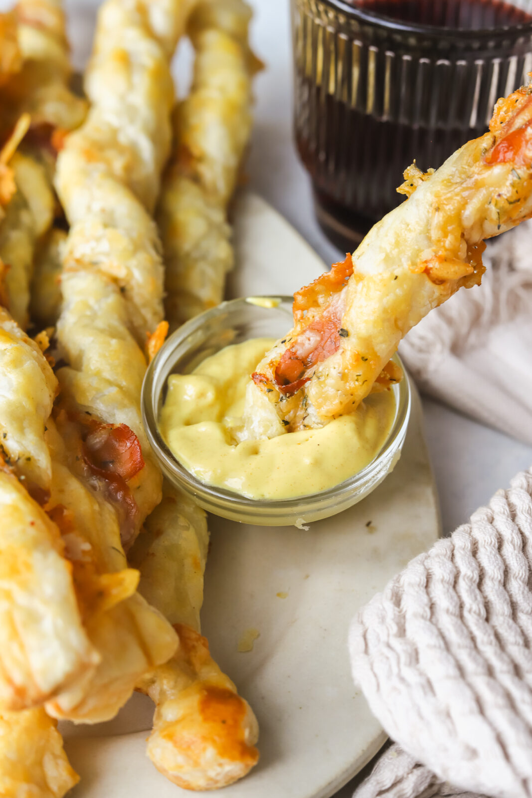 dipping a cheese twist in mustard