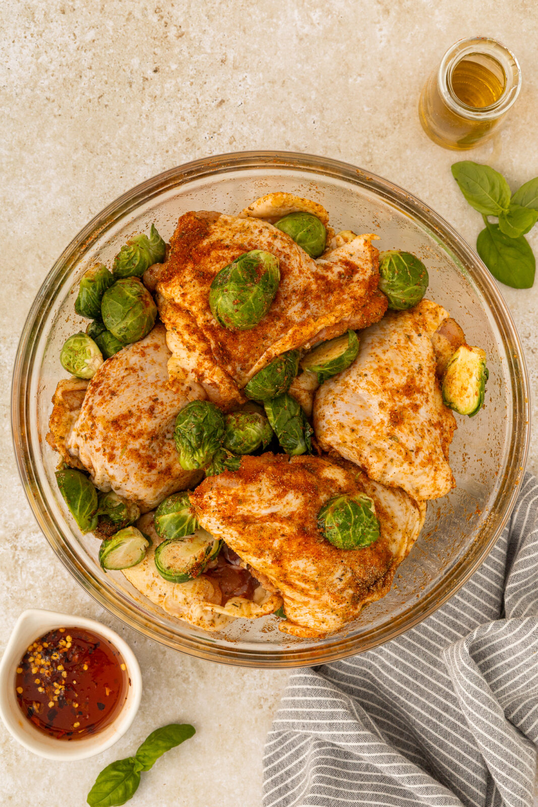 chicken thighs in a bowl with brussels sprouts