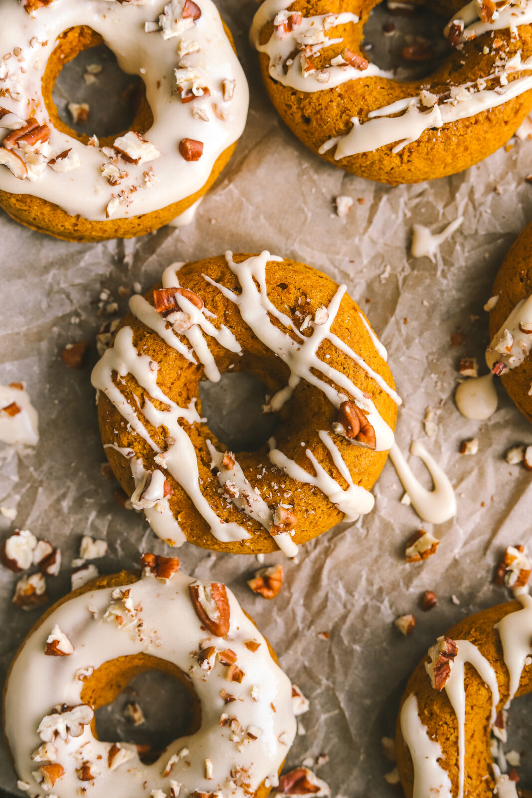 close up of pumpkin donut with maple icing