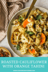 roasted cauliflower in a serving dish with orange tahini sauce