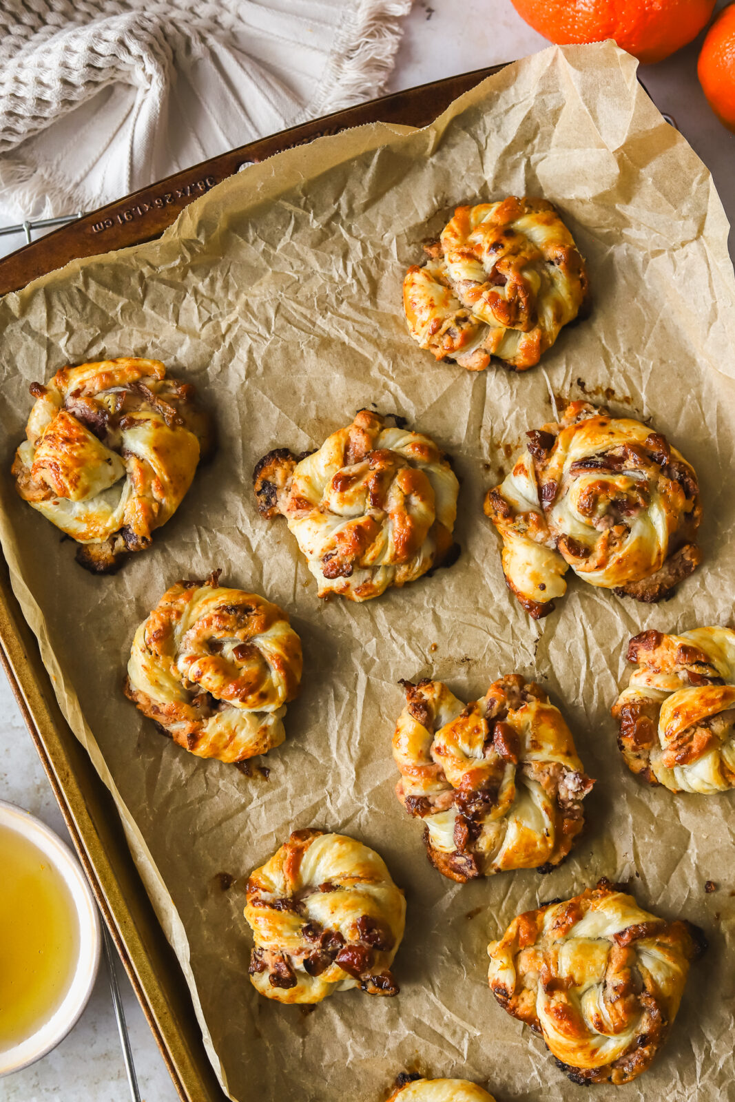 golden brown puff pastry swirls on a baking sheet