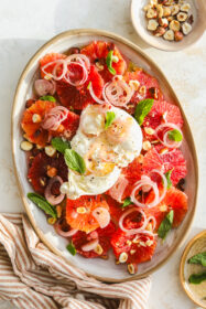 Blood Orange Salad with Burrata, Hazelnuts & Mint overhead of burrata ball on top of blood orange salad