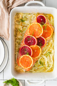 salmon topped with citrus in a baking dish with fennel