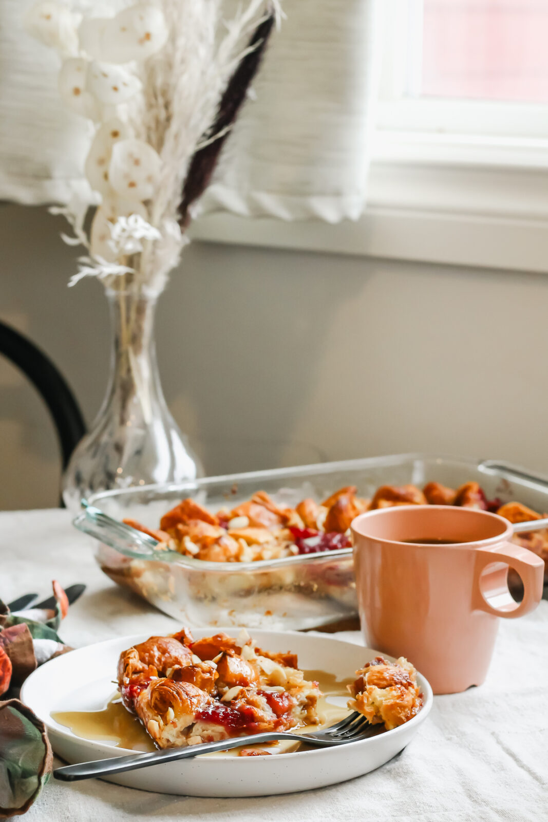 table set with french toast bake, coffee and flowers