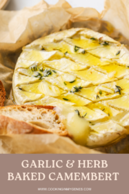 angled shot of baked camembert with garlic and herbs