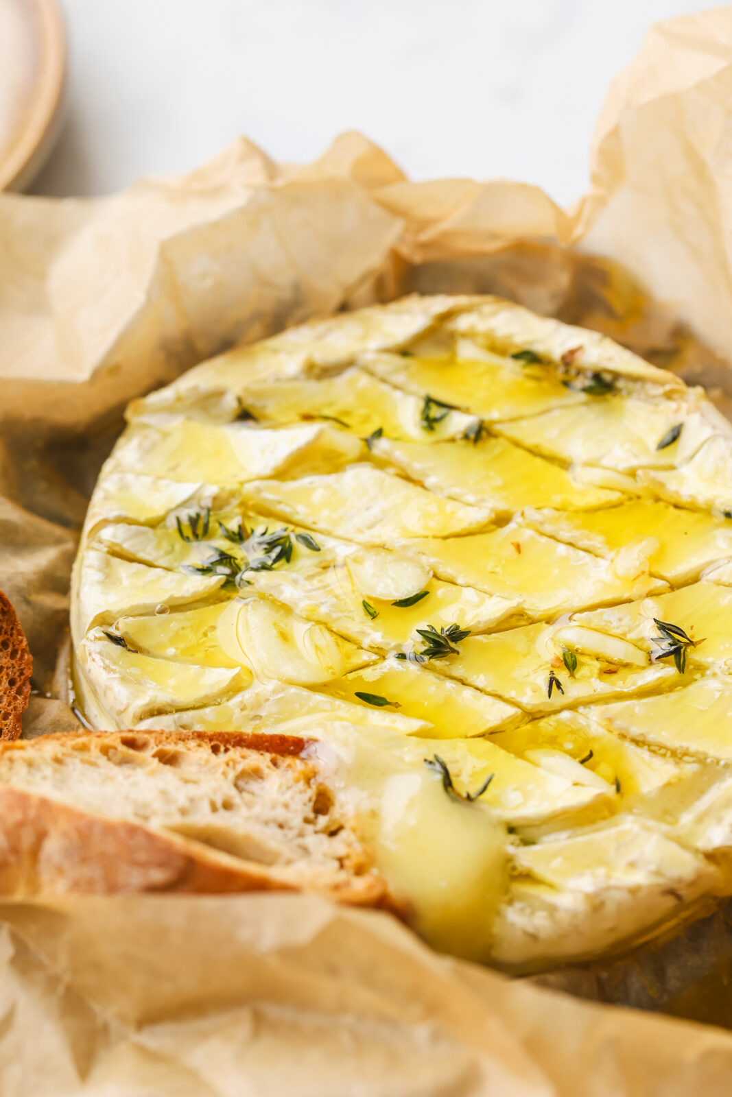 angled shot of baked camembert with garlic and herbs