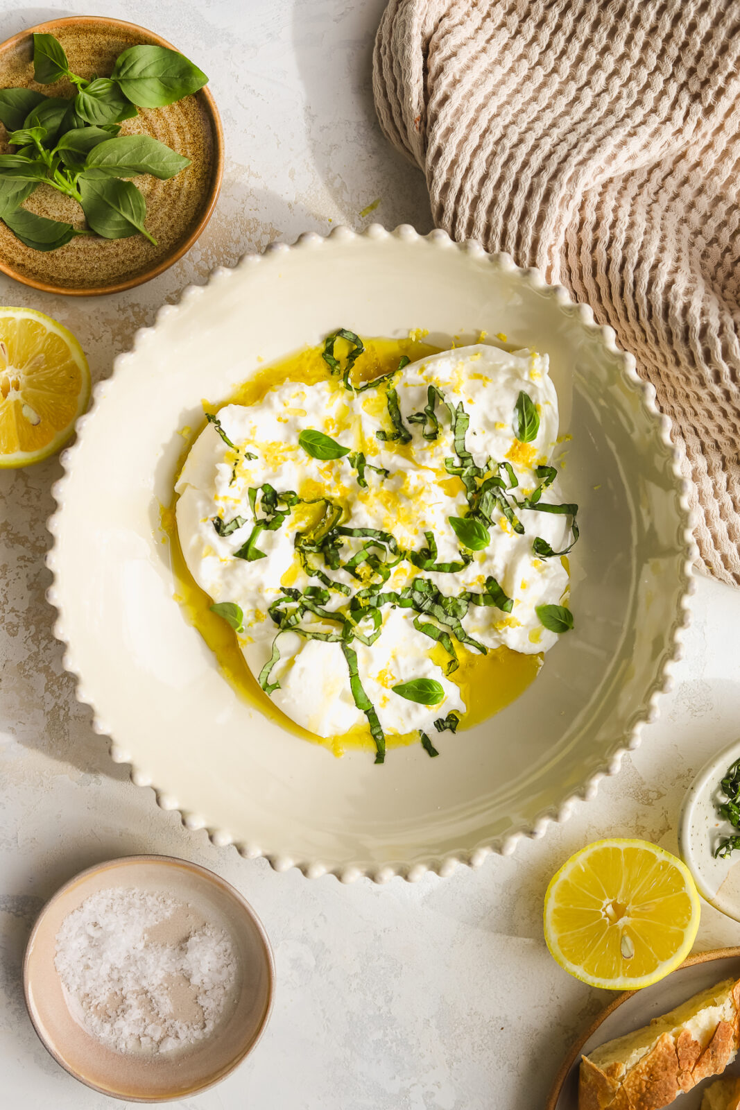 burrata appetizer with fresh basil and lemon zest in a bowl