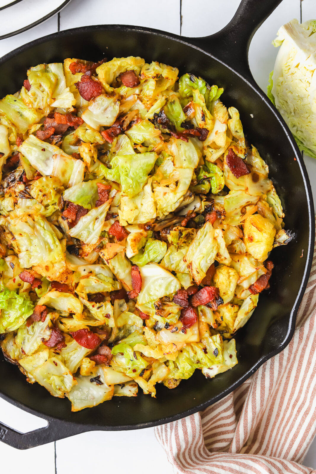 savoy cabbage and bacon sauteed in a cast iron pan