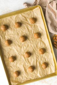 almond butter cookie dough balls on a baking sheet