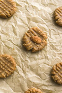 close up of almond cookie with a full almond on top