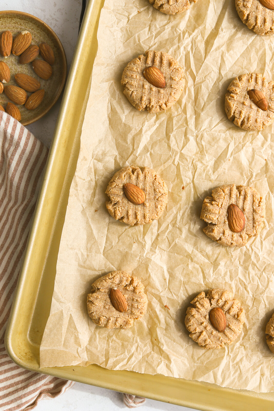 baked almond butter cookies on a baking sheet