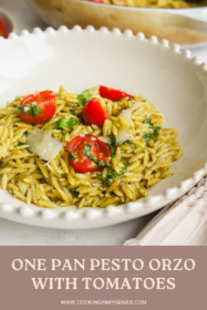 pesto orzo with tomatoes in a beige bowl