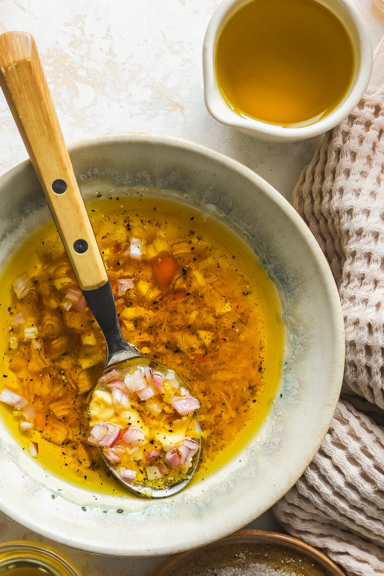 lemon vinaigrette mixed in a bowl with a spoon
