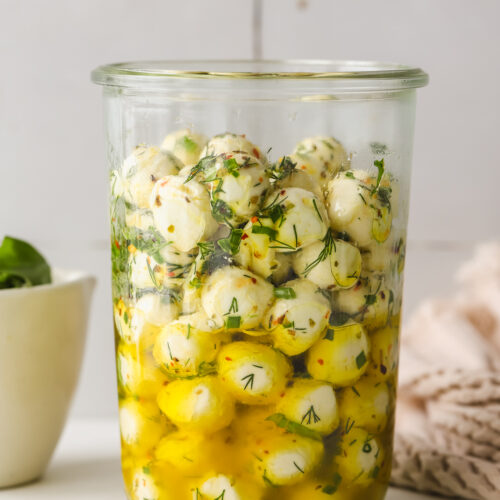 large glass jar with marinated mozzarella balls