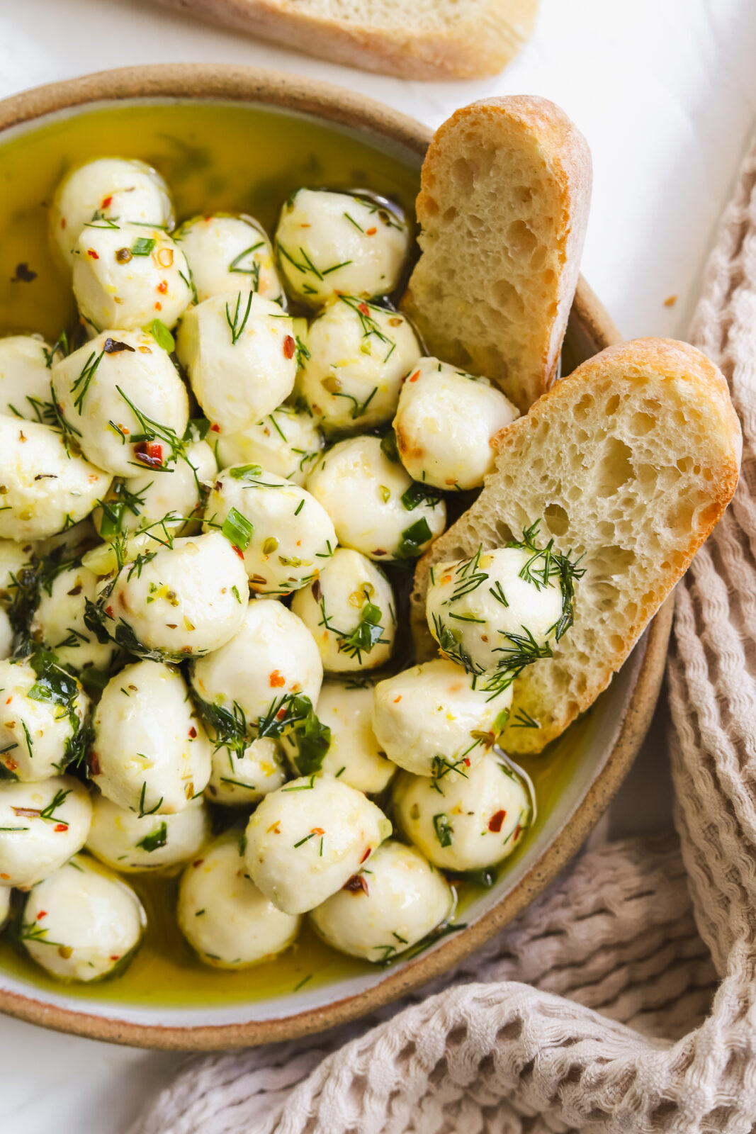 close up of a mozzarella ball with herbs and spices