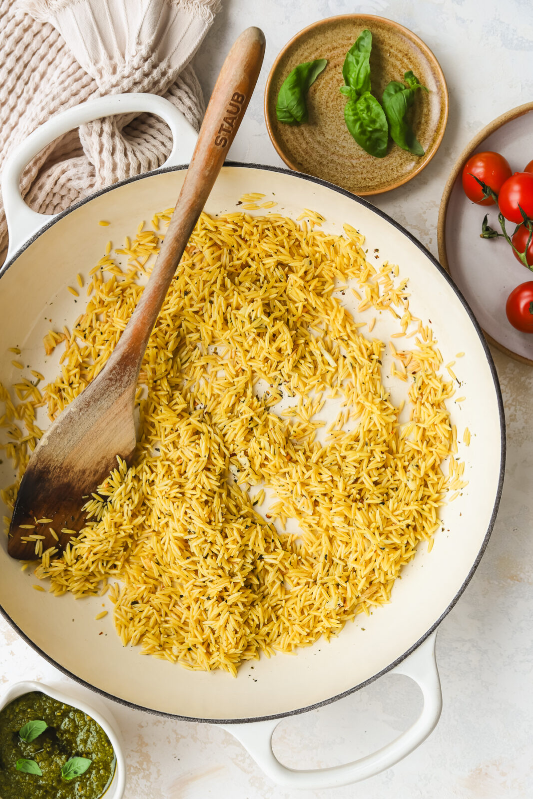 dry orzo in a pan with spices