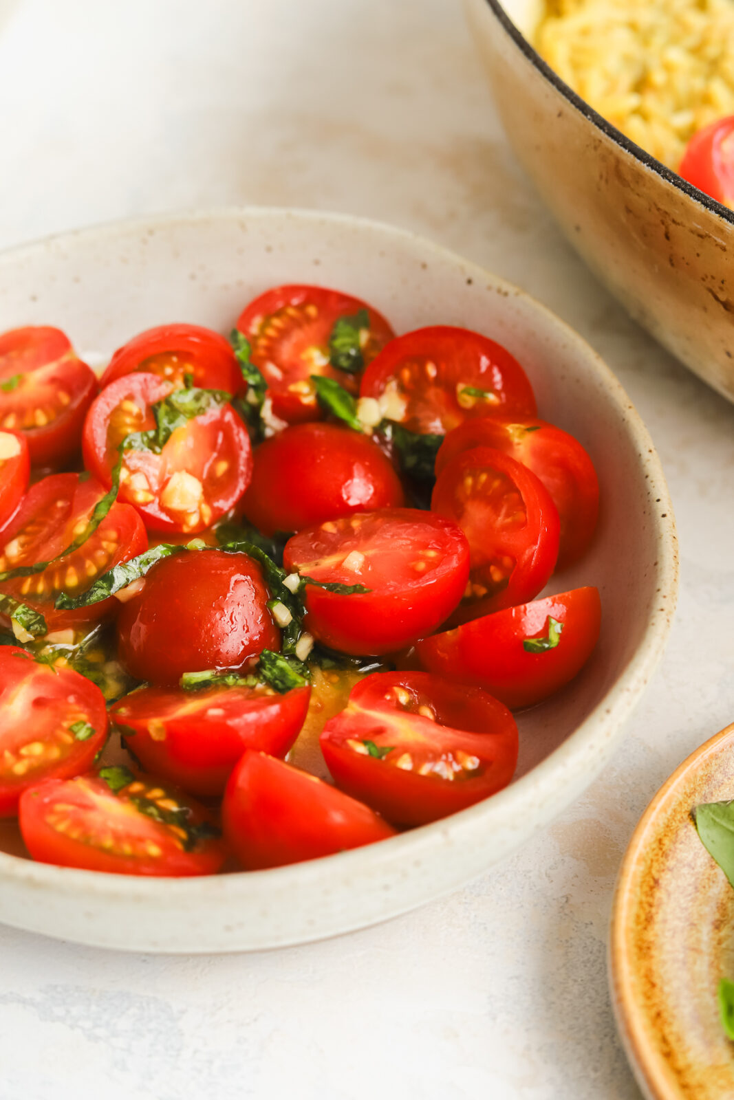 fresh tomatoes in a bowl with basil
