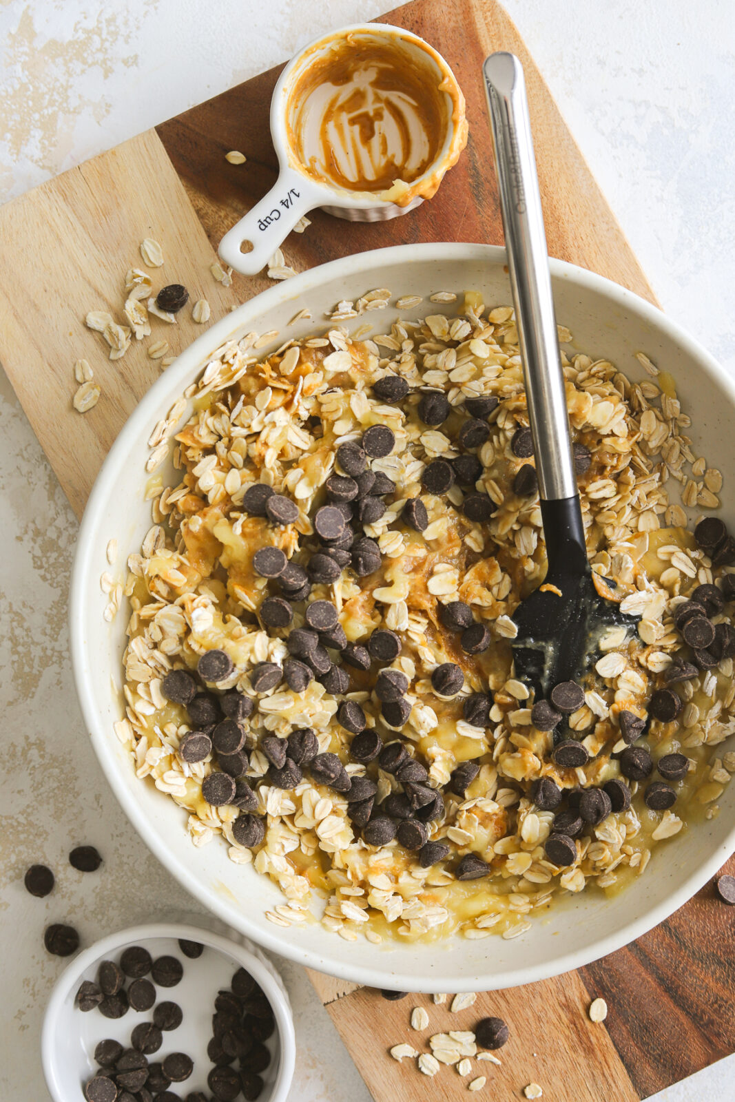 bowl with mashed banana mixed with chocolate chips and oats