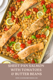 a sheet pan with burst tomatoes, butter beans and salmon fillets