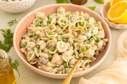 Creamy Green Goddess Pasta Salad (Perfect for meal prep) close up of a spoon in a serving bowl of pasta salad
